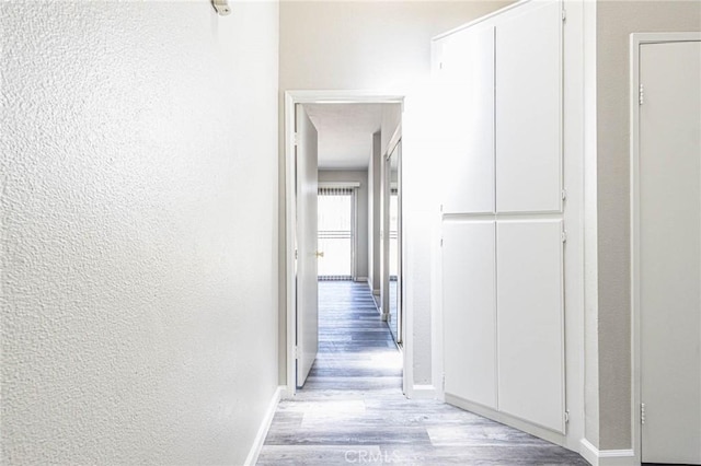 14292 Pinewood Dr, Hesperia, CA 92344 - hallway featuring light wood-type flooring, baseboards, and a textured wall
