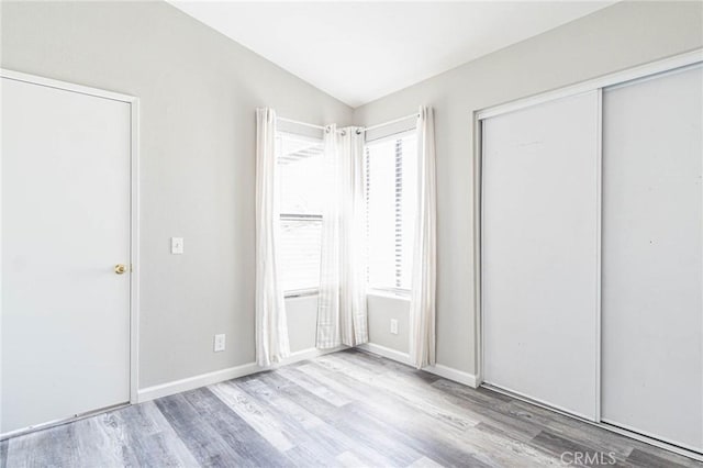 14292 Pinewood Dr, Hesperia, CA 92344 - unfurnished bedroom featuring vaulted ceiling, wood finished floors, a closet, and baseboards