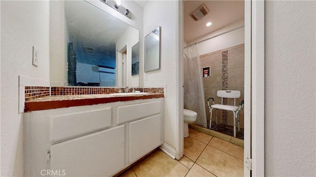 bathroom with vanity, visible vents, toilet, tile patterned floors, and a stall shower
