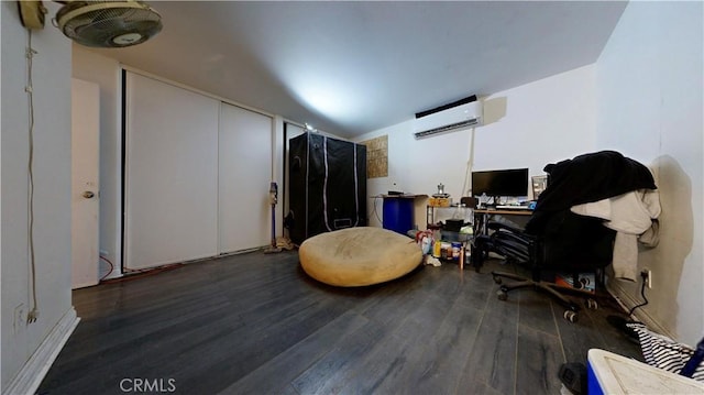 home office featuring a wall mounted AC and wood finished floors