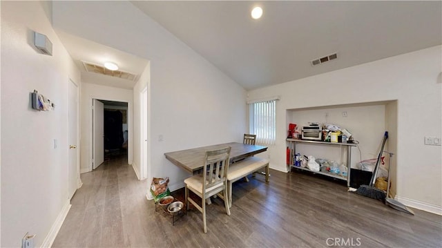 dining room featuring visible vents, baseboards, and wood finished floors