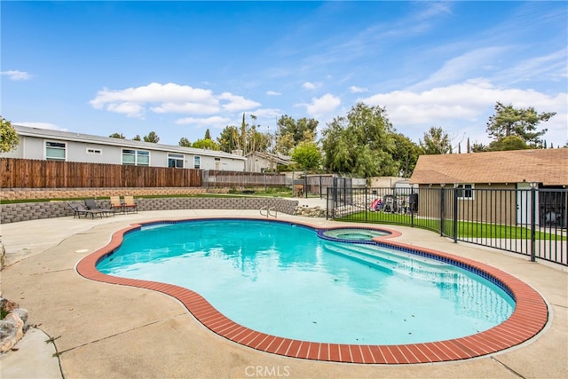 view of swimming pool featuring fence, a pool with connected hot tub, and a patio area