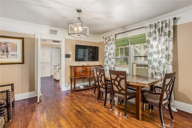 dining room with crown molding, baseboards, wood finished floors, and a chandelier