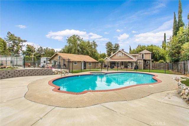view of swimming pool with a fenced in pool, an in ground hot tub, fence, and a patio area