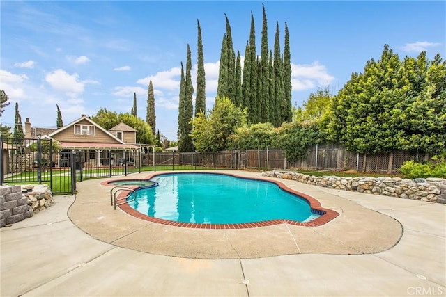 view of pool with a fenced in pool, a fenced backyard, and a patio area