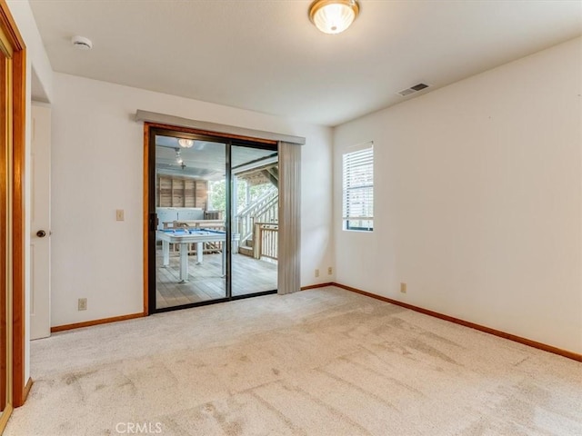 empty room with visible vents, carpet flooring, and baseboards