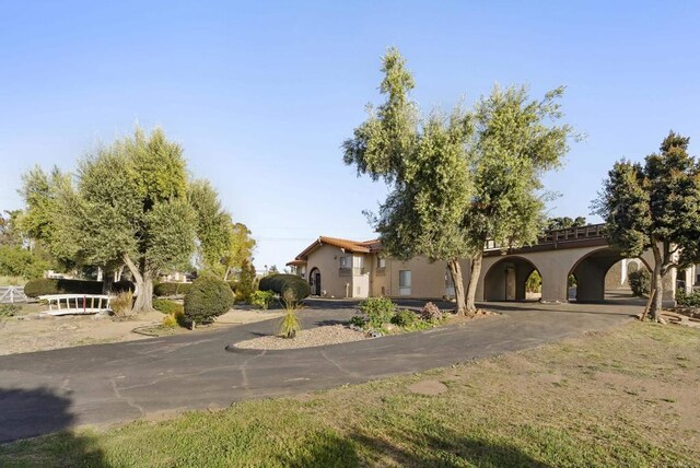 2409 Dehesa Rd, El Cajon, CA 92019 - view of front of home with curved driveway, a carport, and stucco siding
