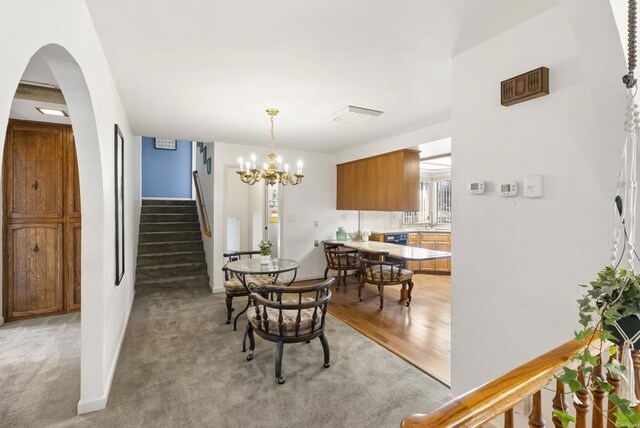 2409 Dehesa Rd, El Cajon, CA 92019 - dining room with stairway, light wood finished floors, a notable chandelier, and arched walkways
