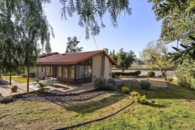 2409 Dehesa Rd, El Cajon, CA 92019 - rear view of property featuring a tile roof, a patio, a sunroom, a yard, and stucco siding