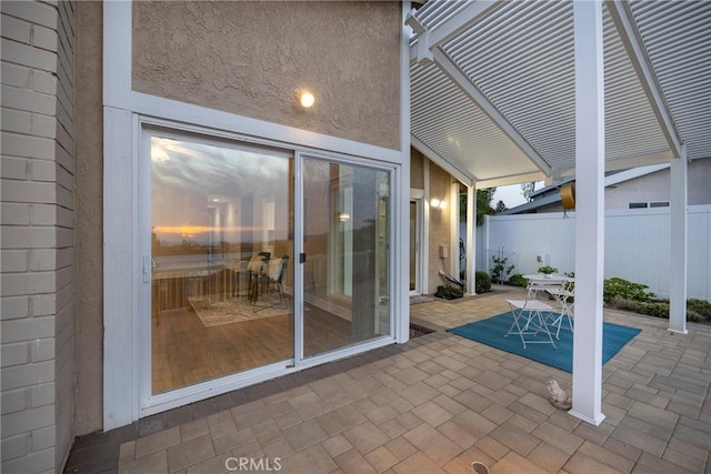 view of patio with outdoor dining space and fence