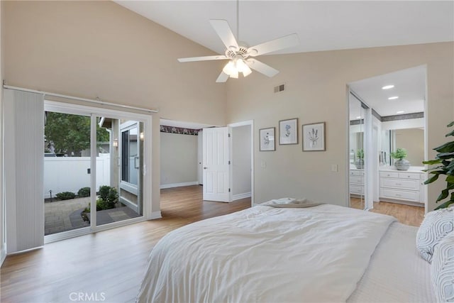bedroom with wood finished floors, access to exterior, baseboards, and visible vents