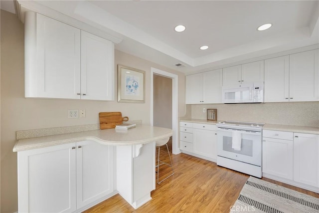 kitchen featuring white cabinets, white appliances, and light countertops