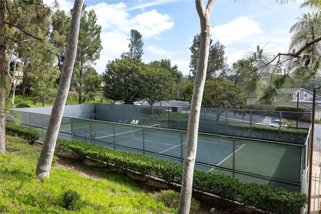view of sport court featuring fence