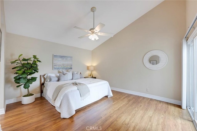 bedroom with light wood finished floors, baseboards, high vaulted ceiling, and ceiling fan