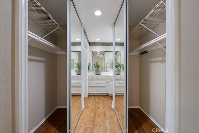 walk in closet with light wood-type flooring