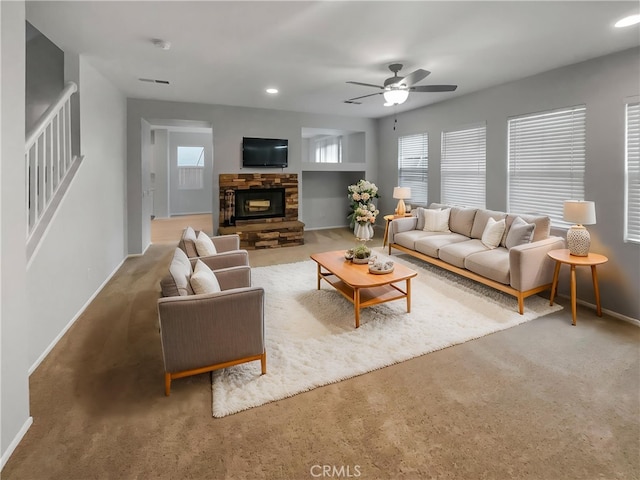 carpeted living room featuring recessed lighting, a fireplace, ceiling fan, visible vents, and baseboards