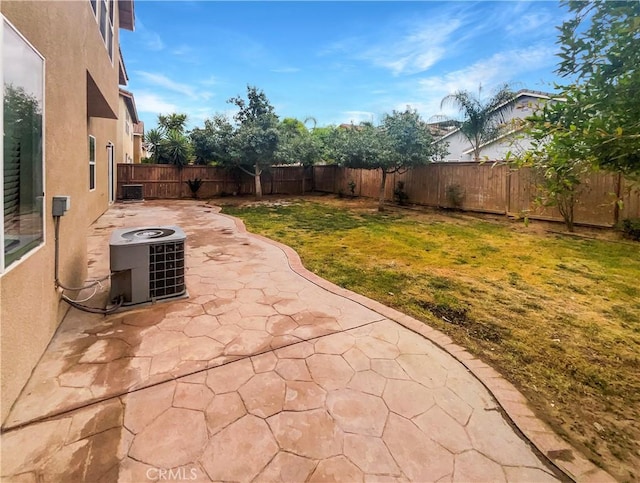 view of patio with a fenced backyard and central air condition unit