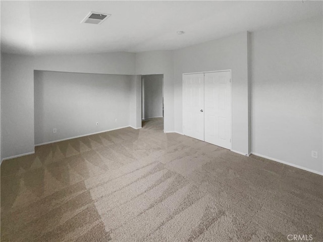 unfurnished bedroom featuring baseboards, visible vents, and carpet