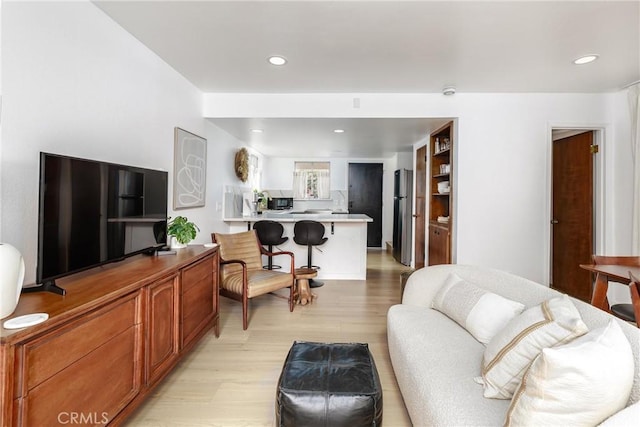 living area featuring recessed lighting and light wood-type flooring