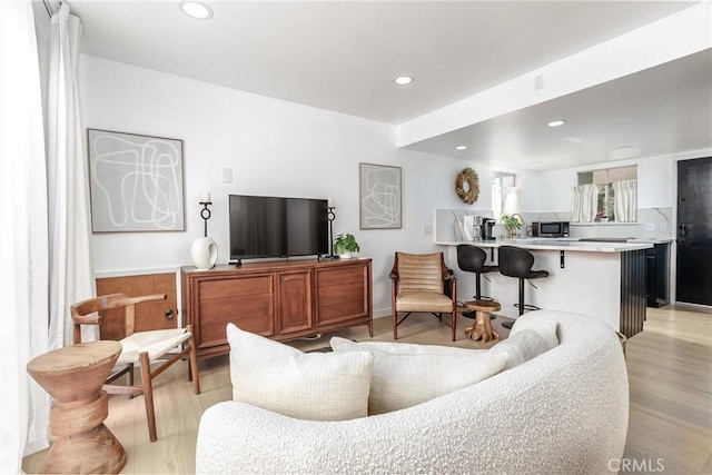 living area featuring recessed lighting and light wood-style flooring