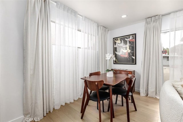 dining space with recessed lighting, baseboards, plenty of natural light, and light wood-style flooring