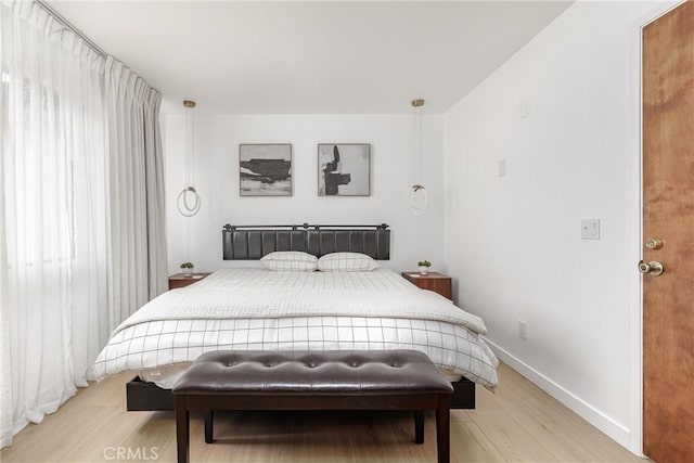 bedroom with baseboards and light wood-style floors