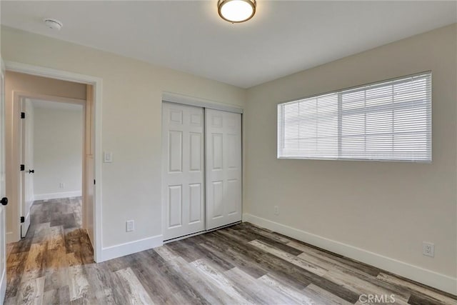 402 E Glendale Dr, Orange, CA 92865 - unfurnished bedroom featuring wood finished floors, baseboards, and a closet