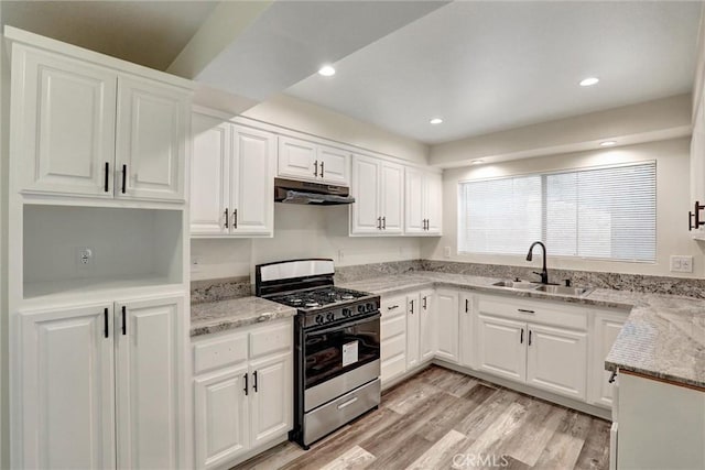 402 E Glendale Dr, Orange, CA 92865 - kitchen featuring stainless steel range with gas cooktop, a sink, under cabinet range hood, light stone countertops, and white cabinetry