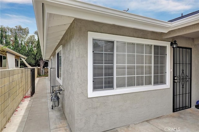 402 E Glendale Dr, Orange, CA 92865 - property entrance with stucco siding, fence, and a patio
