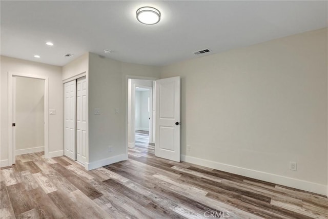 402 E Glendale Dr, Orange, CA 92865 - unfurnished bedroom featuring wood finished floors, baseboards, recessed lighting, and a closet