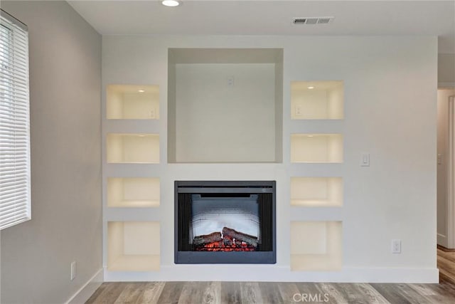402 E Glendale Dr, Orange, CA 92865 - unfurnished living room featuring built in shelves, wood finished floors, a fireplace, baseboards, and recessed lighting