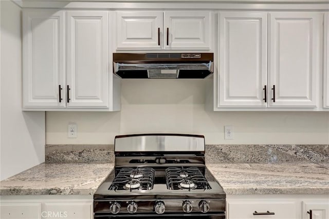 402 E Glendale Dr, Orange, CA 92865 - kitchen with under cabinet range hood, black gas range, white cabinetry, and light stone counters