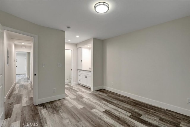402 E Glendale Dr, Orange, CA 92865 - unfurnished bedroom featuring wood finished floors, baseboards, ensuite bathroom, and recessed lighting