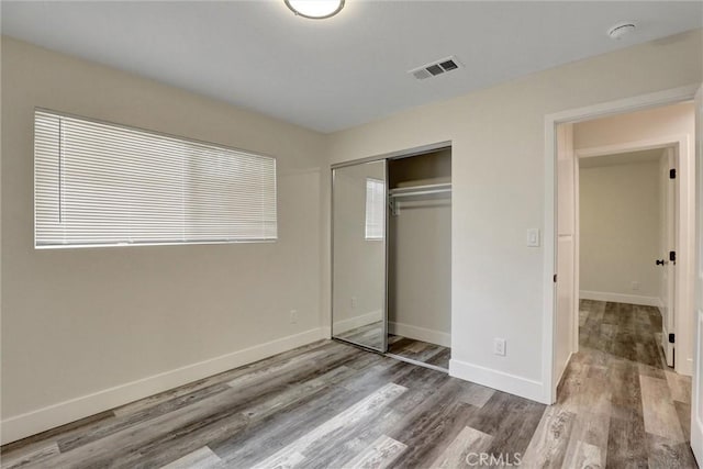 402 E Glendale Dr, Orange, CA 92865 - unfurnished bedroom with wood finished floors, baseboards, and a closet