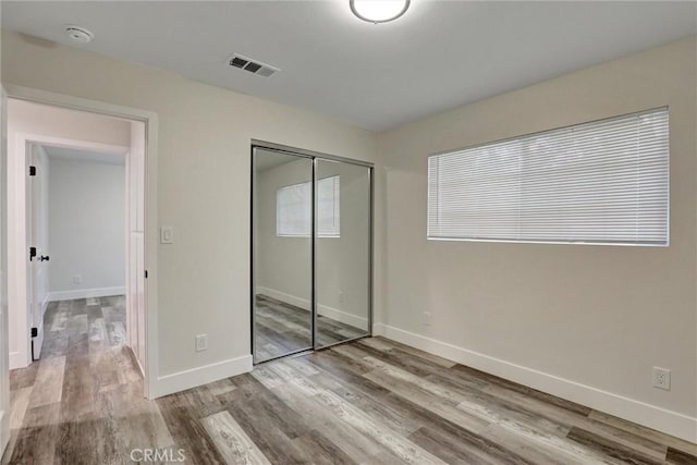 402 E Glendale Dr, Orange, CA 92865 - unfurnished bedroom with wood finished floors, a closet, and baseboards