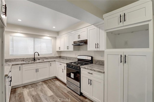 402 E Glendale Dr, Orange, CA 92865 - kitchen with stainless steel gas stove, a sink, under cabinet range hood, white cabinets, and recessed lighting