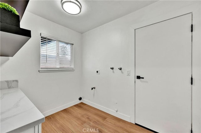 laundry area featuring light wood-style flooring, hookup for an electric dryer, baseboards, hookup for a washing machine, and laundry area
