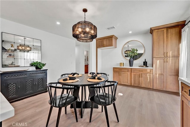 dining room featuring light wood-style flooring, visible vents, an inviting chandelier, and recessed lighting