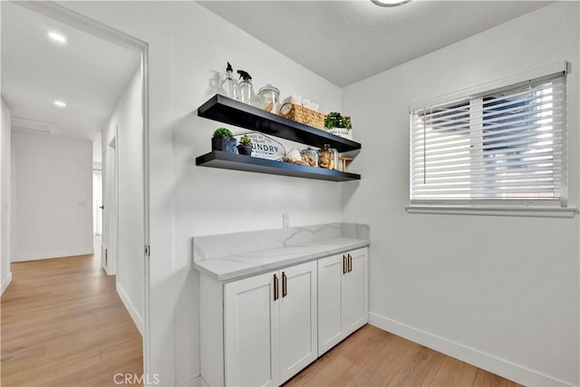 bar with baseboards and light wood finished floors