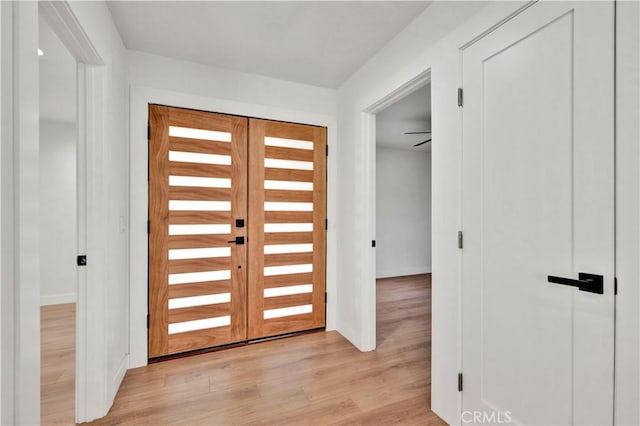 entryway featuring baseboards and light wood-style floors