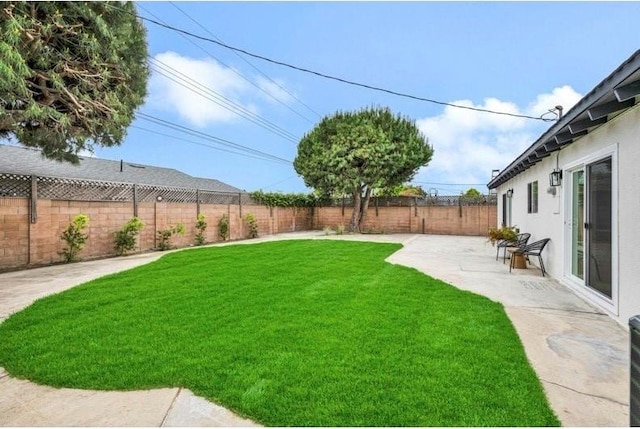 view of yard featuring a fenced backyard and a patio