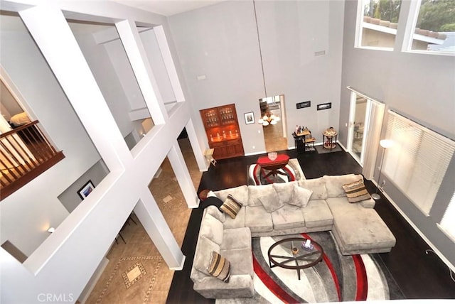 23801 Hollingsworth Dr, Murrieta, CA 92562 - stairs featuring baseboards, a high ceiling, and wood finished floors