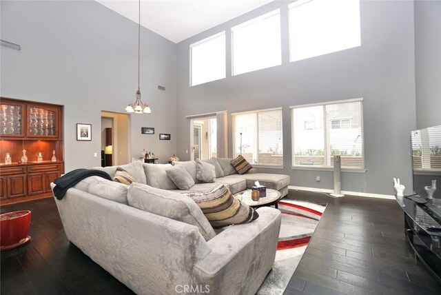 23801 Hollingsworth Dr, Murrieta, CA 92562 - living area with a high ceiling, an inviting chandelier, a healthy amount of sunlight, and visible vents