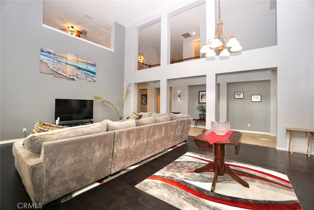 23801 Hollingsworth Dr, Murrieta, CA 92562 - living area with an inviting chandelier, visible vents, wood finished floors, baseboards, and a high ceiling