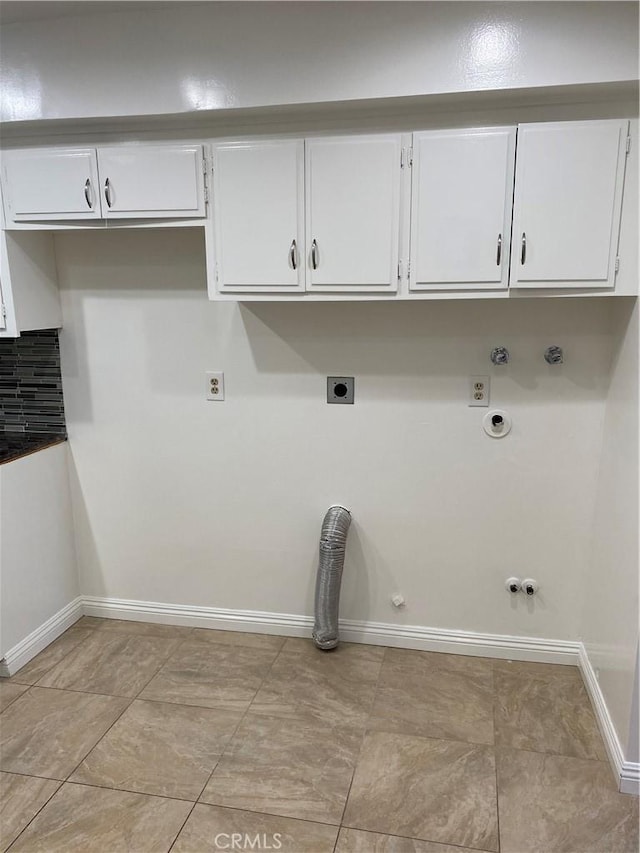 clothes washing area with hookup for an electric dryer, hookup for a gas dryer, hookup for a washing machine, baseboards, and cabinet space