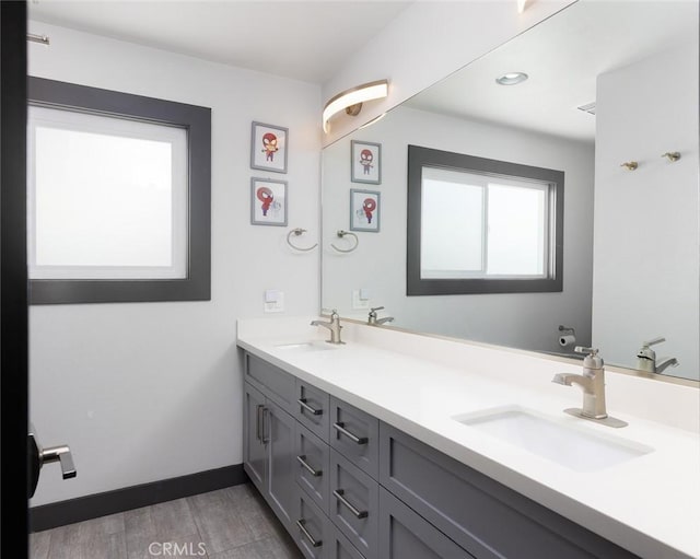 1055 N Mallard St, Orange, CA 92867 - bathroom featuring double vanity, wood finished floors, baseboards, and recessed lighting