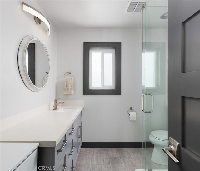 1055 N Mallard St, Orange, CA 92867 - full bathroom with vanity, toilet, a stall shower, wood finished floors, and baseboards