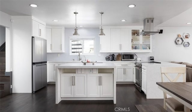 1055 N Mallard St, Orange, CA 92867 - kitchen with appliances with stainless steel finishes, island range hood, dark wood-style flooring, light countertops, and recessed lighting