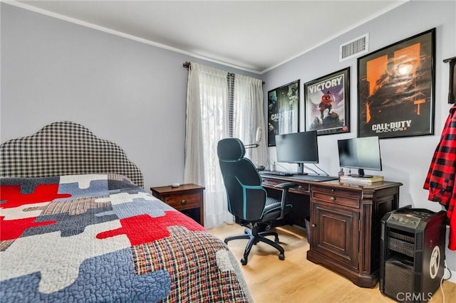 bedroom with ornamental molding, visible vents, and light wood-type flooring