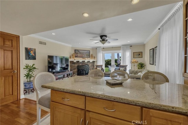 1506 Ameluxen Ave, Hacienda Heights, CA 91745 - kitchen featuring open floor plan, ornamental molding, a ceiling fan, light stone counters, and a stone fireplace